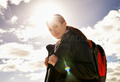 Buy stock photo Ready, sky and portrait of woman hiking in adventure or outdoor travel for holiday vacation. Clouds, sunshine or nomad explorer trekking in journey, nature or trip exercise for wellness or walking