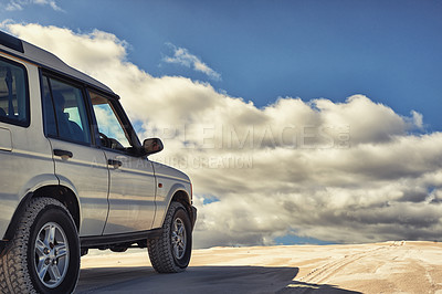 Buy stock photo Dunes, vehicle and sky with clouds, adventure and transport on road trip for holiday. Outdoor, sand and 4x4 for travel in Dubai for desert landscape, nature and truck in sunshine and wilderness