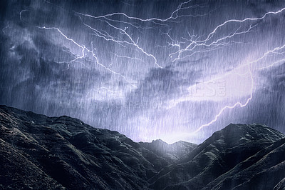 Buy stock photo Shot of a dramatic thunderstorm over a mountain