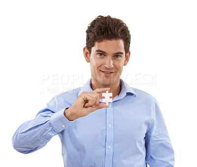 Buy stock photo Portrait, puzzle and problem solving with a man in studio isolated on a white background holding a piece. Face, creative or connect and a male employee looking confident with a jigsaw in hand