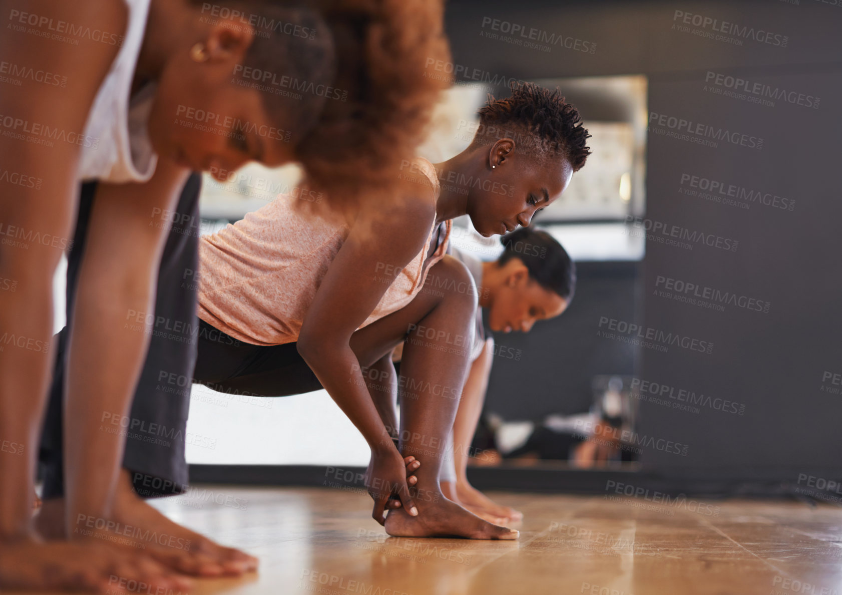 Buy stock photo Dancer, group and stretching legs in studio for workout, exercise or vision for wellness with muscle. People, friends and dancing team in warm up, start or together for class, art and ballet on floor