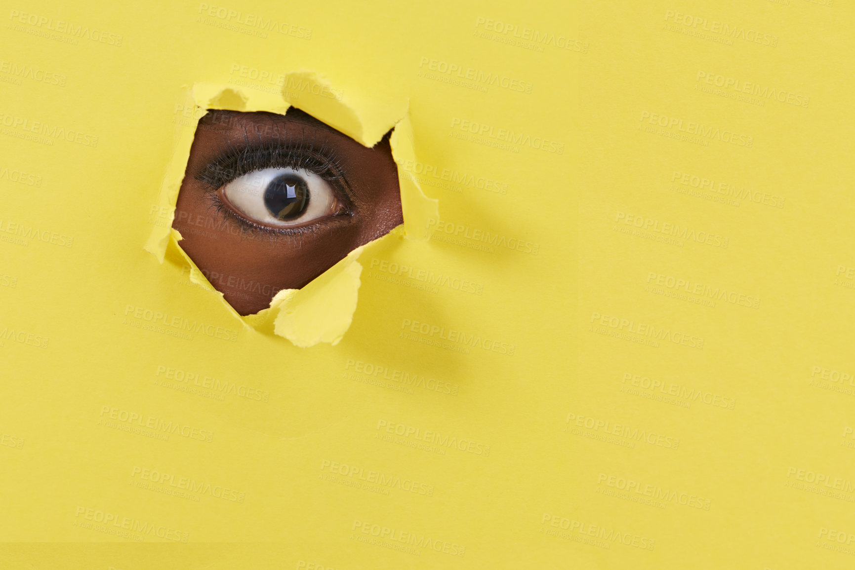 Buy stock photo A view of a woman&#039;s eye looking through a hole in some colorful paper