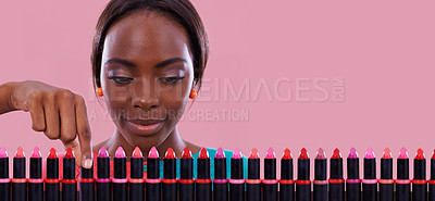 Buy stock photo Lipstick, makeup and choice of color with black woman in studio isolated on pink background for cosmetics. Face, retail and shopping for beauty product with young customer on space for decision