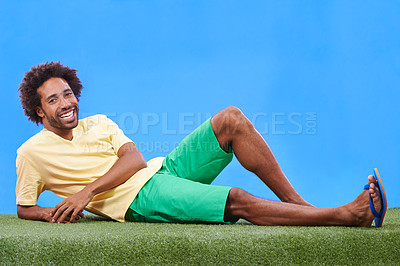 Buy stock photo A young african man relaxing on the grass