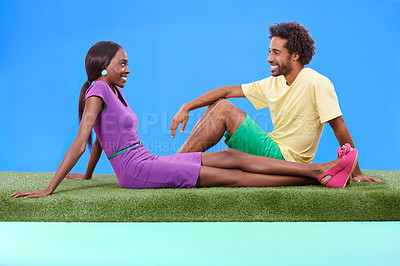 Buy stock photo A young african couple sitting on the grass together