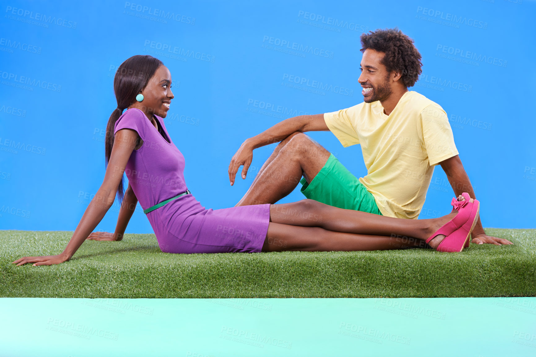 Buy stock photo A young african couple sitting on the grass together