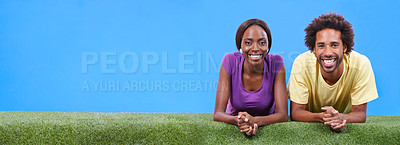 Buy stock photo A young african couple lying on the grass together