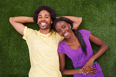 Buy stock photo Couple, portrait and top view with smile on grass for bonding, support and outdoor date in garden of home. African woman, man and face with relax on lawn for weekend break at park in nature with love