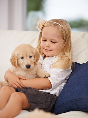 Buy stock photo Cropped shot of a little girl holding a puppy