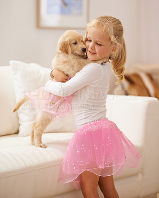 Buy stock photo Golden retriever, hug and child happy together with love, care and development. Cute girl kid and animal puppy or pet in a tutu playing dress up as friends on the home sofa with happiness and trust