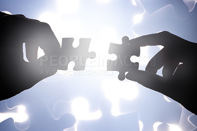 Buy stock photo Cropped shot of hands holding two puzzle pieces