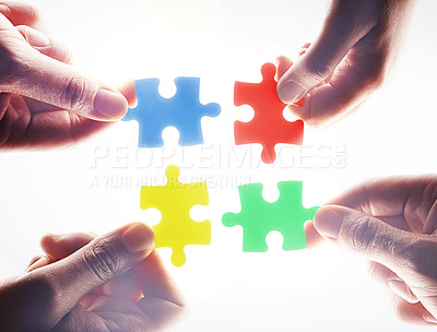 Buy stock photo Hands, puzzle and teamwork in group, problem solving or together for support, glow or color by white background. Team building, jigsaw or strategy for innovation, synergy or solution in collaboration