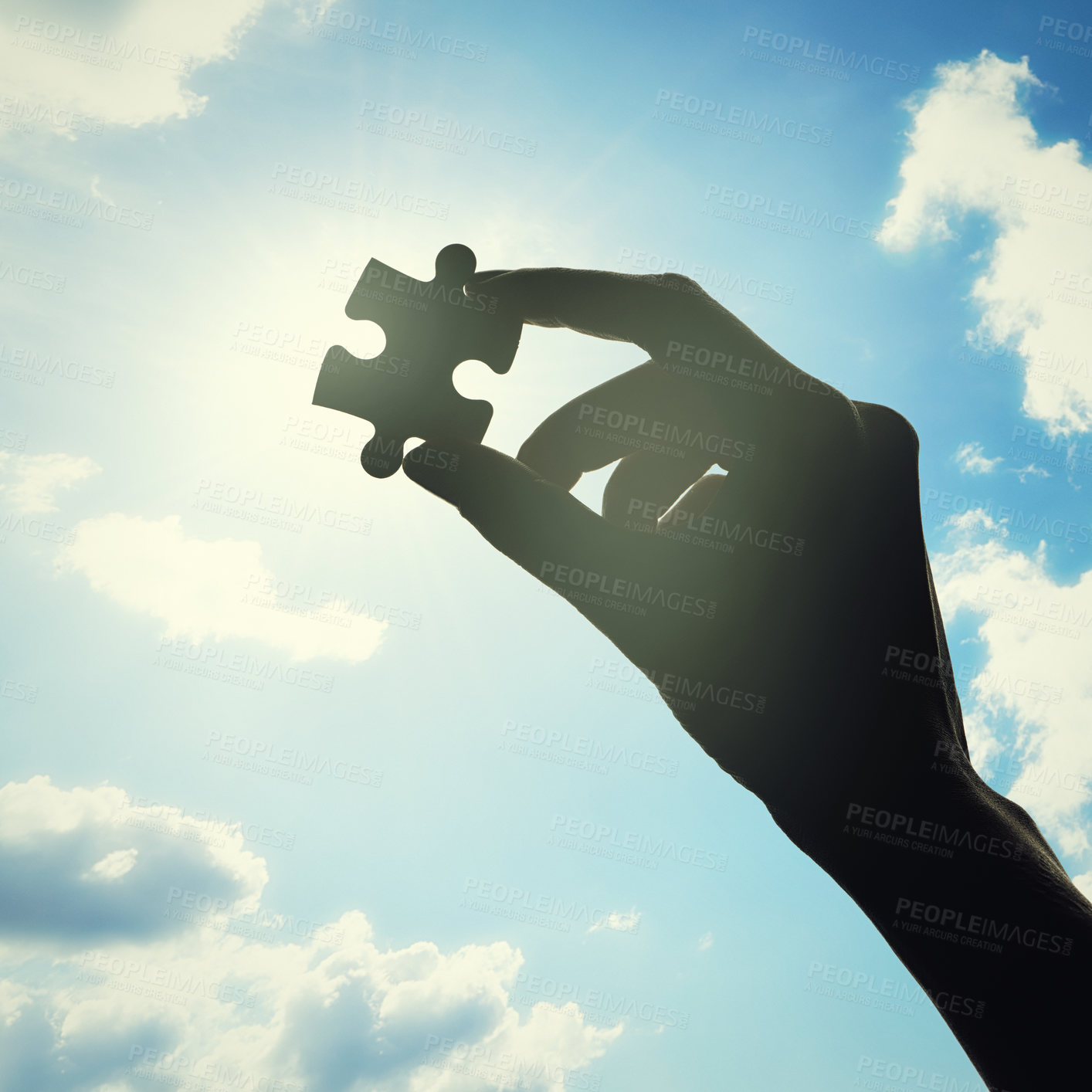 Buy stock photo Hand, puzzle and solution with clouds in sky with problem solving, lens flare or bright ideas in sunshine. Silhouette, jigsaw and light for strategy, innovation or synergy for connection with person