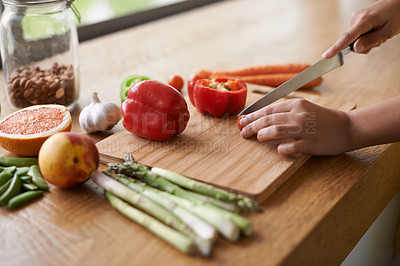 Buy stock photo Close-up cropped image of a woman preparing food on a chopping board