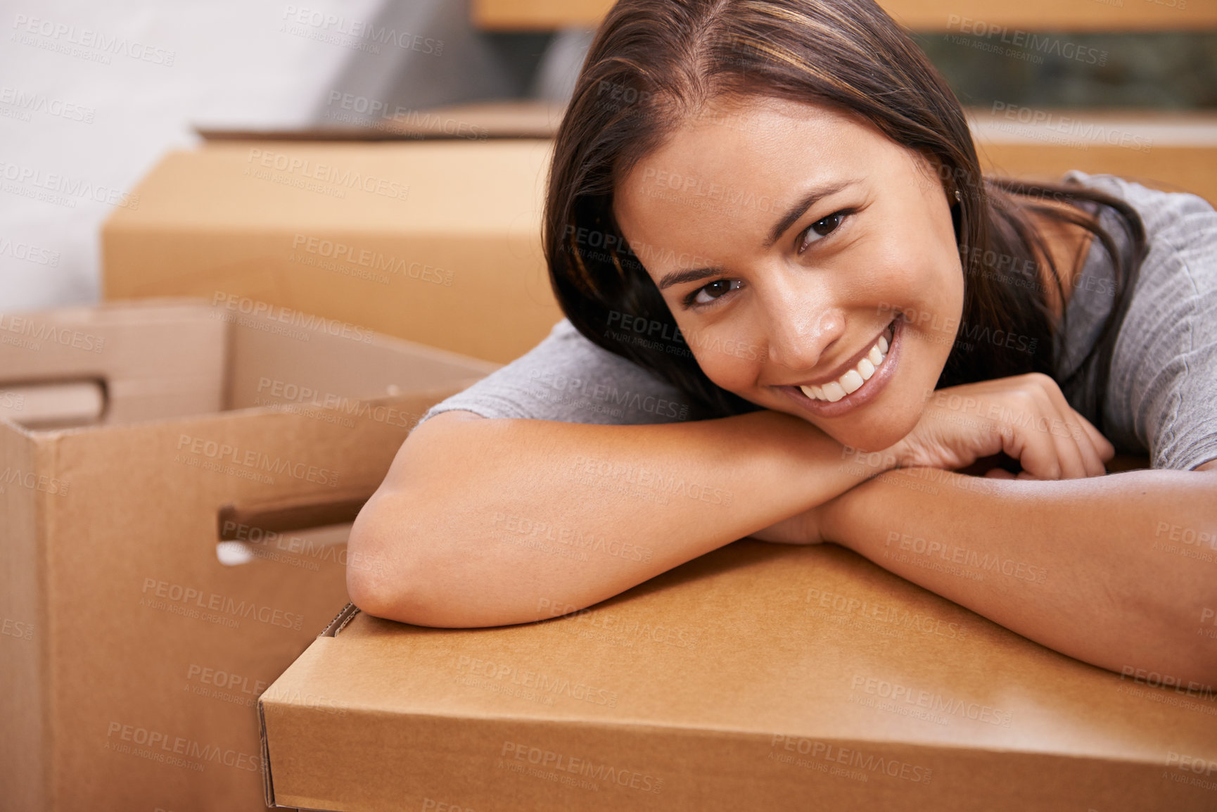 Buy stock photo Woman, portrait and boxes in home, smile and proud of real estate investment and relocation. Female person, happy and mortgage for new property and cardboard for moving house, homeowner and purchase