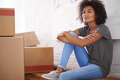 Buy stock photo Shot of a young woman moving into her new house