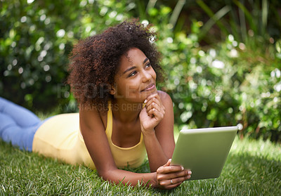 Buy stock photo African woman, tablet and relax on grass with thinking, memory and smile for post on web blog. Girl, digital touchscreen and happy in backyard, garden and outdoor with app for social media in Brazil