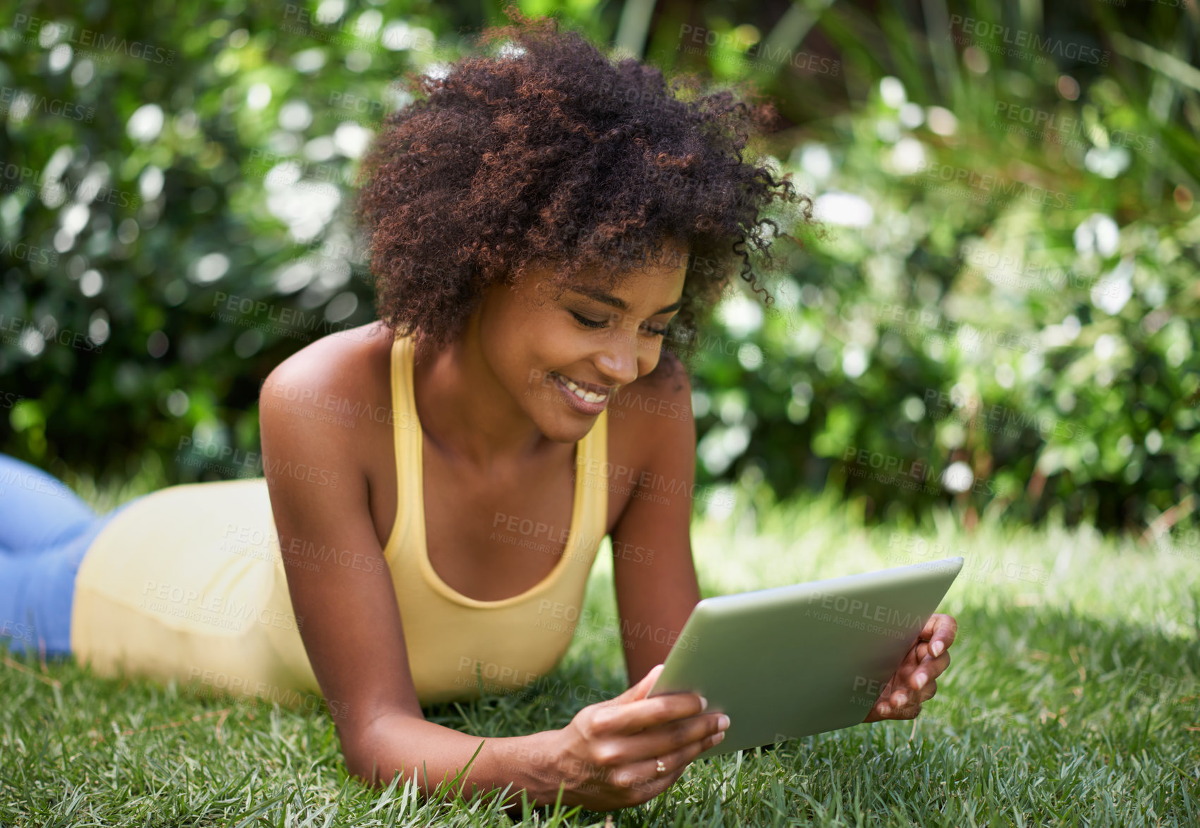 Buy stock photo African woman, tablet and smile on grass with thinking, reading or relax with post on web blog. Girl, digital touchscreen and happy in backyard, garden and outdoor with app for social media in Brazil
