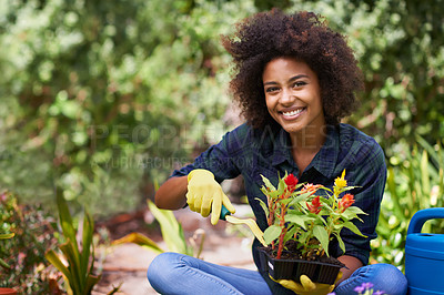 Buy stock photo Portrait of a happy young woman and her tray of plants for the garden
