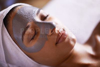 Buy stock photo A young woman relaxing during a facial treatment at a spa
