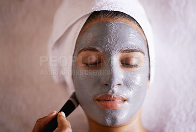 Buy stock photo Shot of a young woman enjoying a facial treatment at a spa
