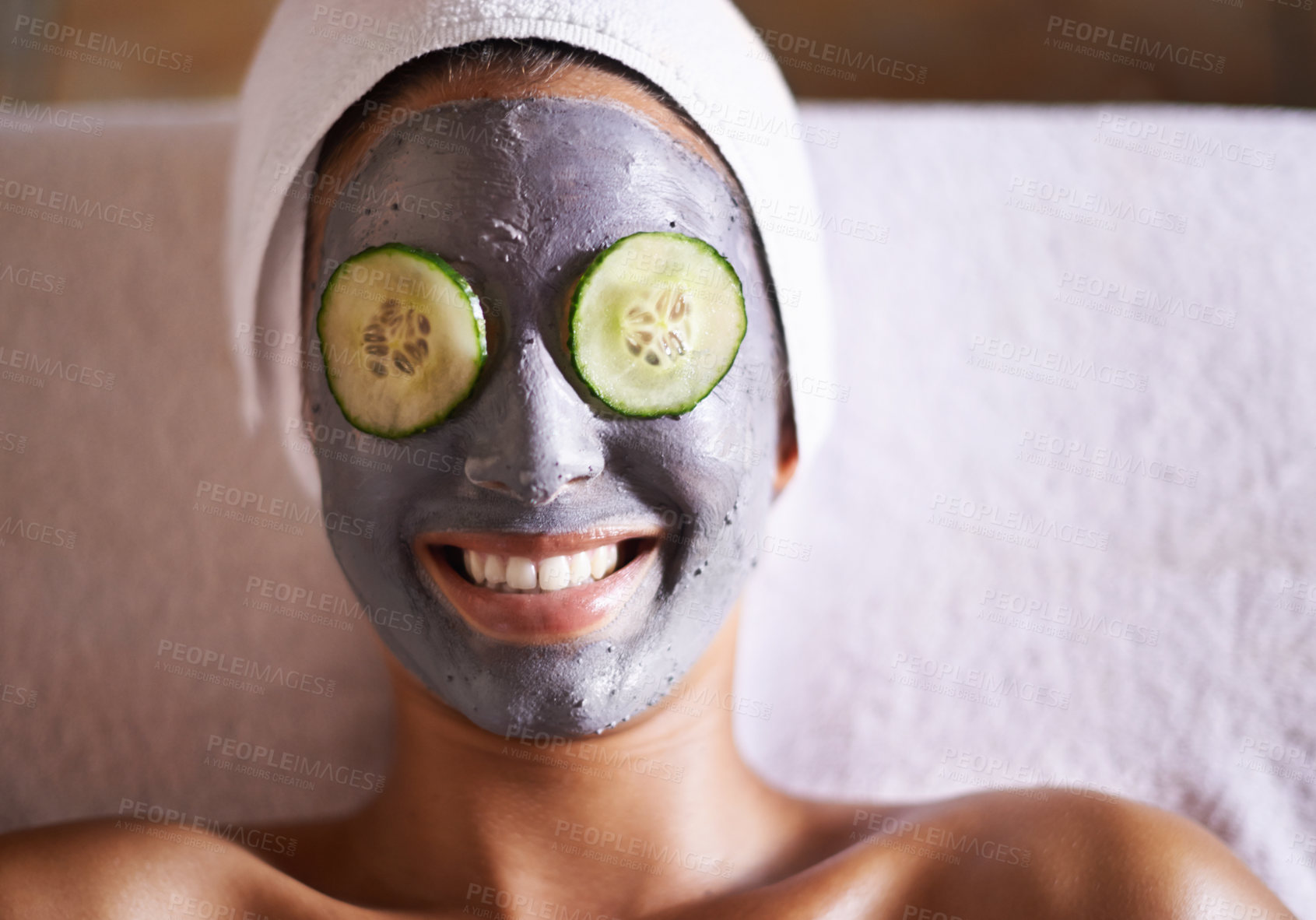 Buy stock photo Woman, cucumber and facial in spa for skincare, beauty and cosmetic treatment for break or peace. Young person and smile with product on face for peel for natural or holistic therapy for wellness