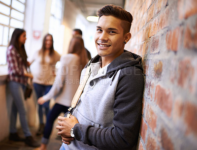 Buy stock photo Education, happy and portrait of man in college hallway for studying, learning and scholarship. Future, smile and knowledge with student leaning on brick wall for university, academy and campus