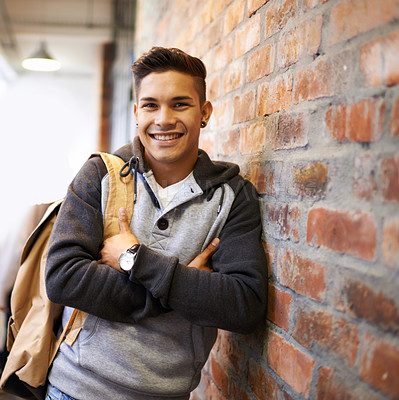 Buy stock photo Learning, smile and portrait of man in school hallway for studying, education and scholarship. Future, happy and knowledge with male student leaning on brick wall for university, academy and campus
