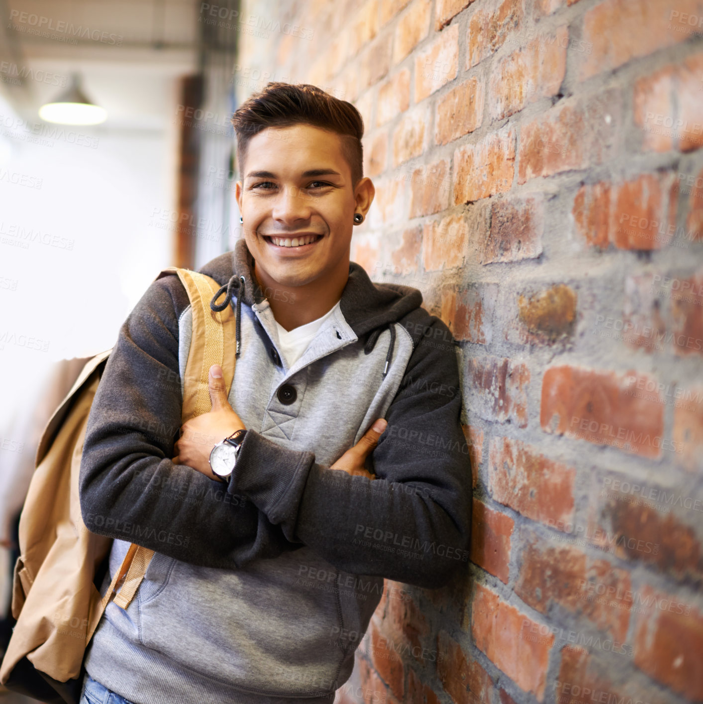 Buy stock photo Learning, smile and portrait of man in school hallway for studying, education and scholarship. Future, happy and knowledge with male student leaning on brick wall for university, academy and campus