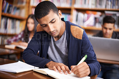 Buy stock photo Study, writing and college with man in library for education, research and classroom quiz. Focus, learning and notebook with male student on university campus for knowledge, scholarship and project