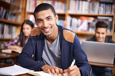 Buy stock photo Cropped portrait of a handsome young student working diligently in his classroom