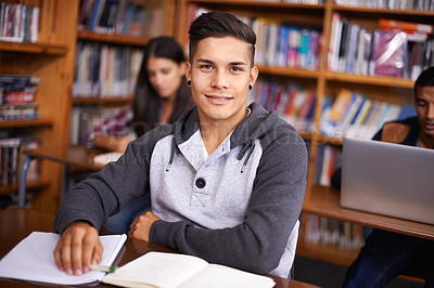 Buy stock photo Young man, portrait  or studying in library for test or scholarship on campus for class assignment. University student, face or happy for education or research in books for exam preparation by desk
