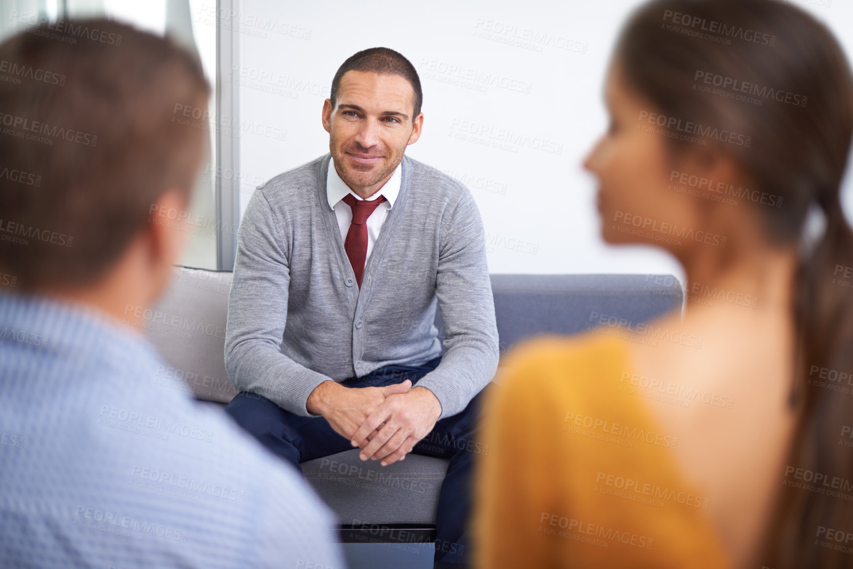 Buy stock photo An attractive businessman being interviewed by two businesspeople