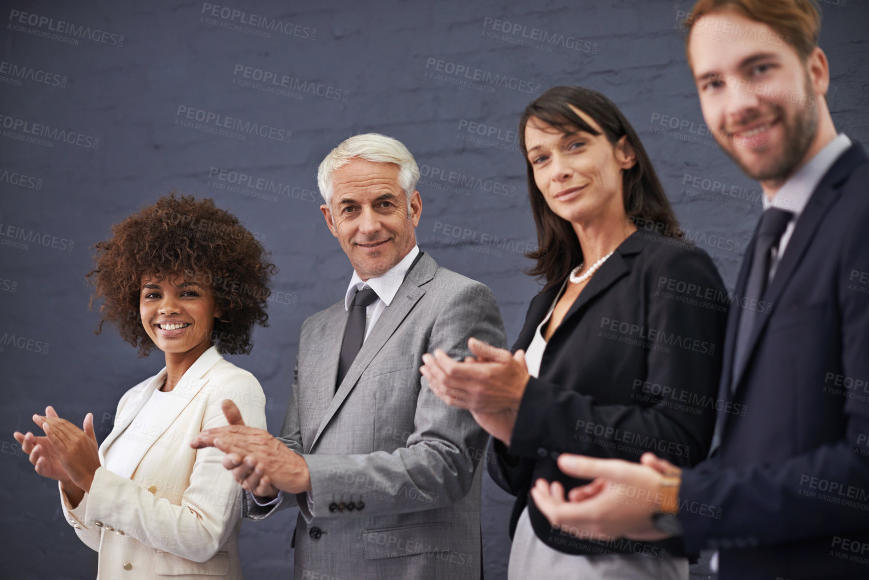 Buy stock photo Portrait of a group of professional coworkers giving a round of applause