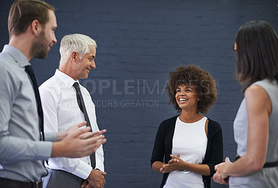 Buy stock photo Shot of a group of professional coworkers enjoying some conversation