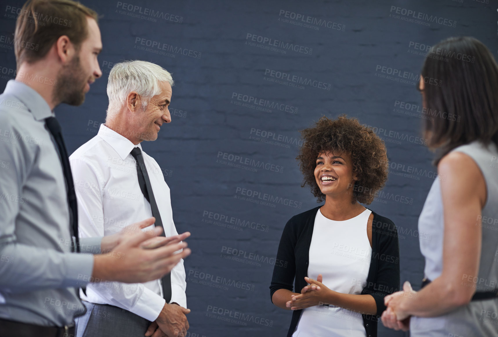 Buy stock photo Shot of a group of professional coworkers enjoying some conversation