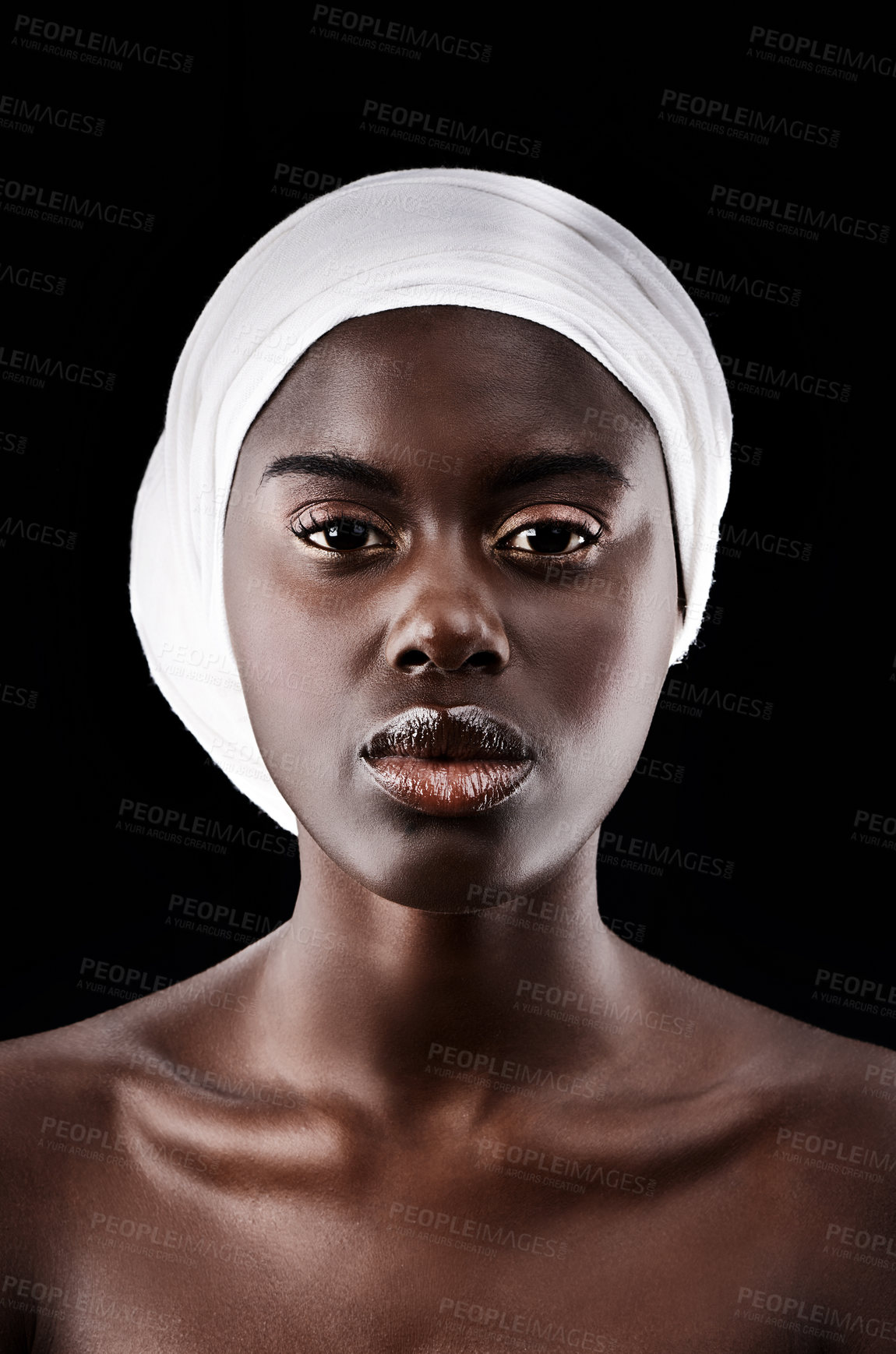 Buy stock photo Studio portrait of a beautiful woman wearing a headscarf against a black background