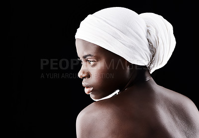 Buy stock photo Studio shot of a beautiful woman wearing a headscarf against a black background