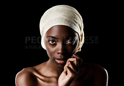 Buy stock photo Studio portrait of a beautiful woman wearing a headscarf against a black background