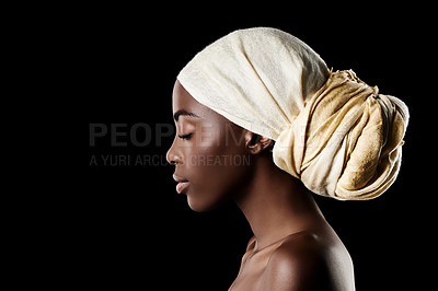 Buy stock photo Studio shot of a beautiful woman wearing a headscarf against a black background