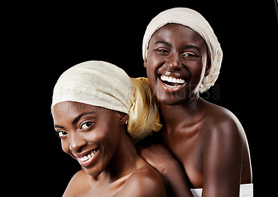 Buy stock photo Studio portrait of two beautiful women wearing headscarves against a black background