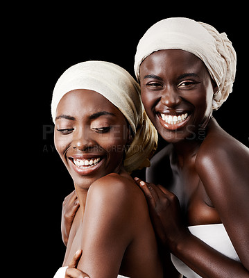 Buy stock photo Black women, head wrap and beauty portrait with smile, skincare and cosmetics in studio with bonding. Girl friends, happy and African scarf with wellness and skin glow with makeup and dark background