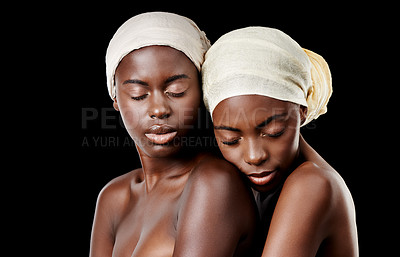 Buy stock photo Turban, hug and African women in studio for wellness, health and hair care treatment. Salon aesthetic, culture and people embrace with accessories, cosmetics and head scarf on black background