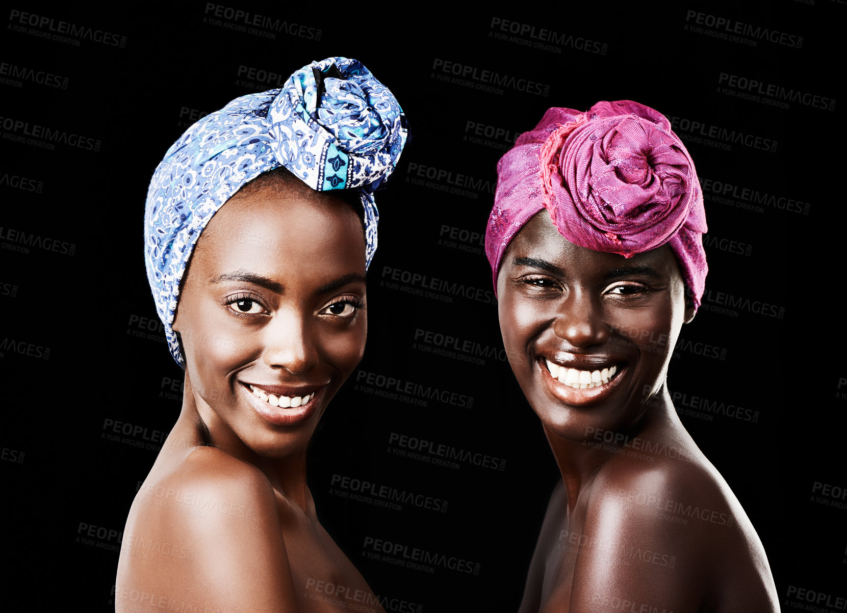 Buy stock photo Studio portrait of two beautiful women wearing headscarves against a black background