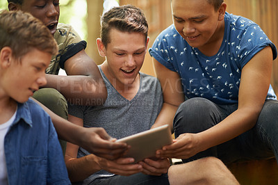 Buy stock photo Happy, tablet and group of boy friends networking on social media, app or internet website. Excited, teenagers and young people scroll, research and browsing on digital technology together on holiday