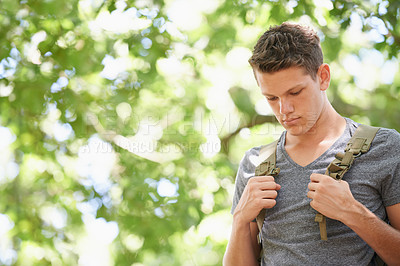 Buy stock photo Teen, backpack and hike outdoors for fitness, trees and plants in nature for trekking on holiday. Male person, mockup and workout for health or wellness, exercise and green environment for peace