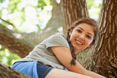 Buy stock photo Smile, portrait and girl climbing tree in nature for adventure in outdoor park, garden or field. Happy, freedom and young teenager sitting on branch with positive, joyful and confident attitude.