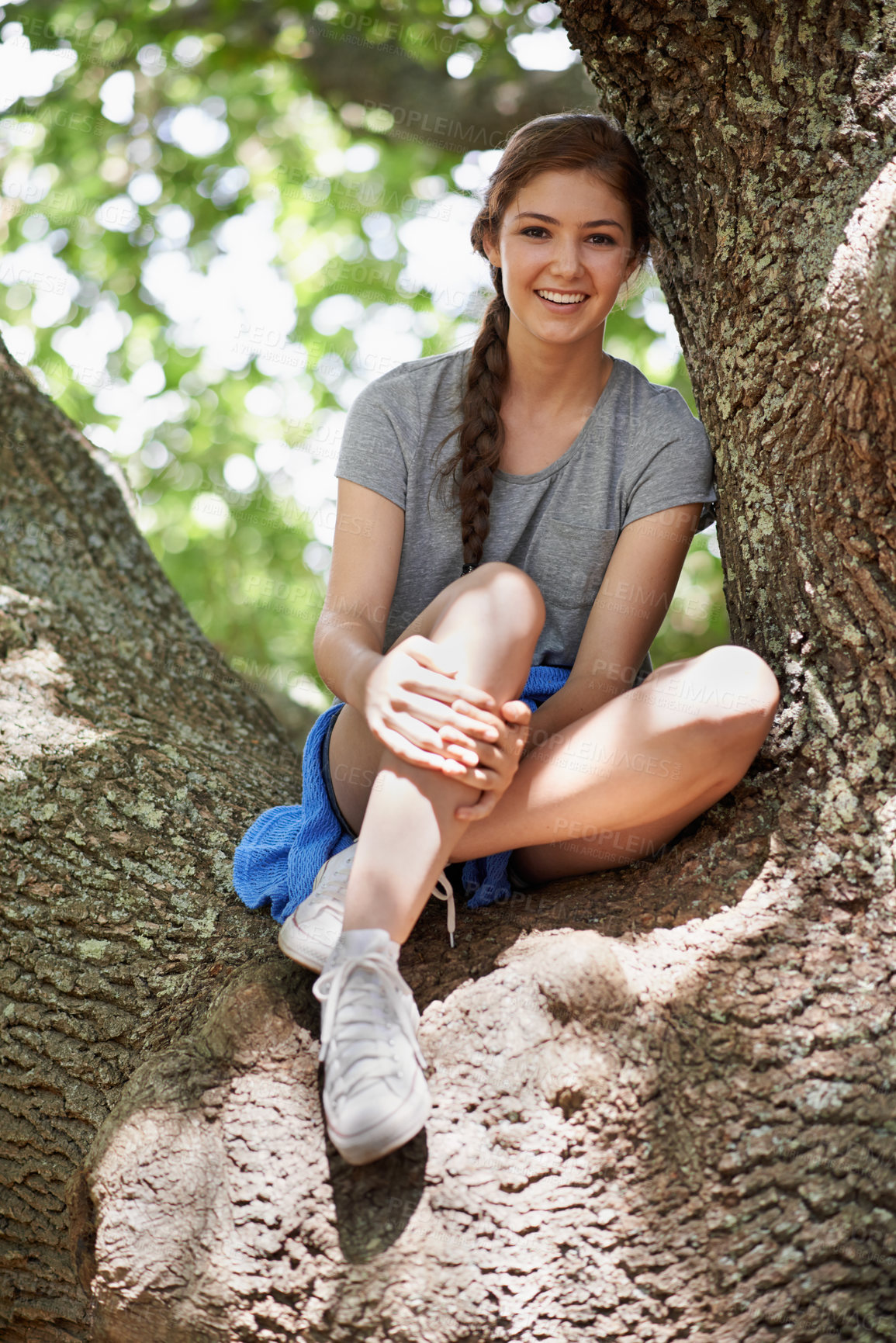 Buy stock photo Teen, girl and portrait outdoors in tree, smile and plants in nature to relax on holiday. Happy female person, enjoy and calm for health or wellness, morning getaway and green environment for peace