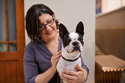 Buy stock photo A middle-aged woman sitting on a bench outside her house with her dog