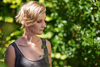 Buy stock photo A cropped shot of a beautful young woman standing in her garden